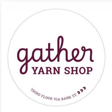 Brick building with 'gather Yarn Shop' sign on a clear day
